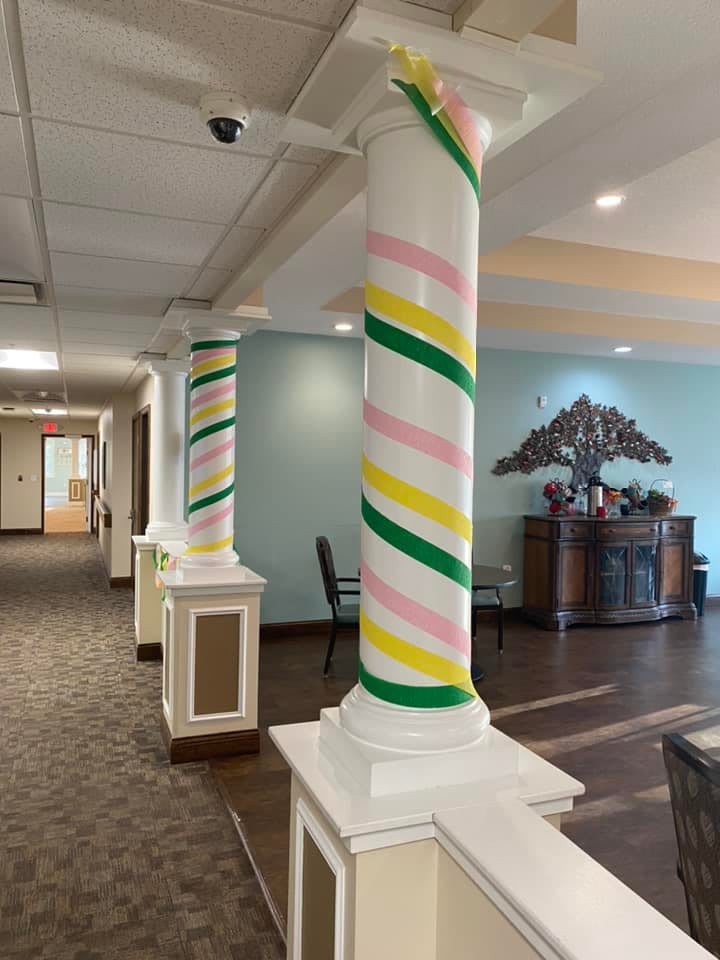 Colorfully wrapped columns in an interior hallway.