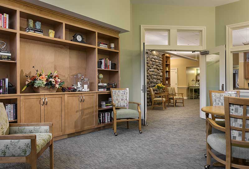 A cozy waiting room with wooden furniture and decorative accents.