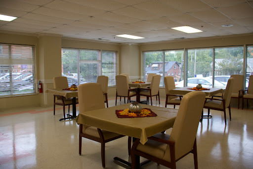 A spacious and well-lit dining area with tables and chairs, designed for comfort and social interaction.