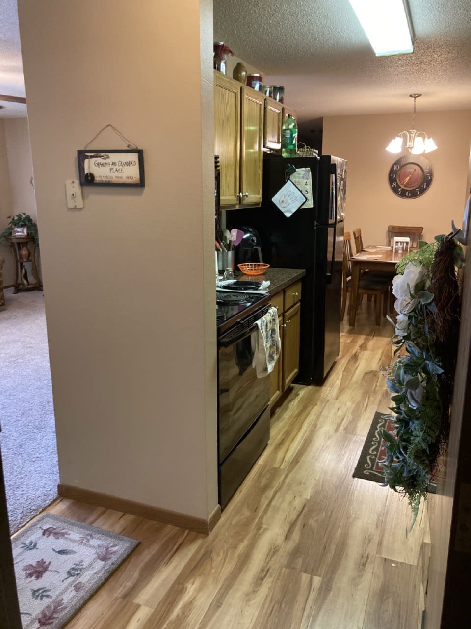 A modern kitchen and dining area with wood flooring and stylish decor.