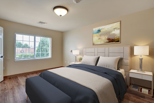 A cozy and elegantly designed bedroom featuring a comfortable bed, stylish decor, and natural light.