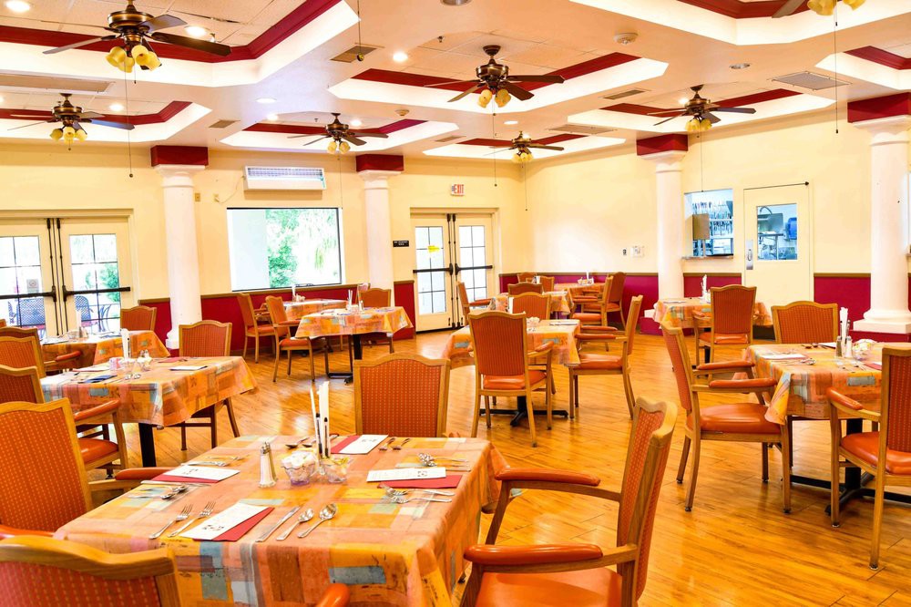An inviting, well-lit restaurant dining area with neatly arranged tables and chairs.
