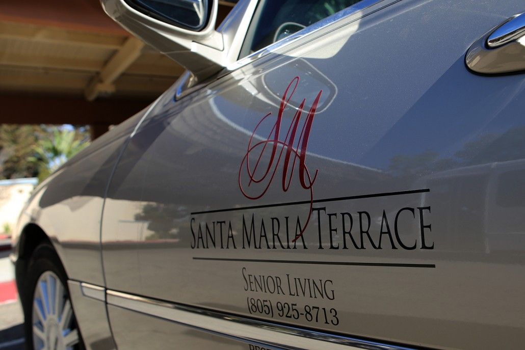 A car featuring the Santa Maria Terrace Senior Living logo and contact information on its side.