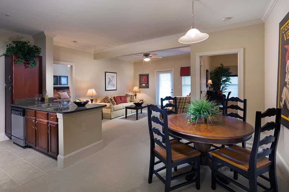 A cozy living space featuring an open floor plan with a dining area and kitchen.