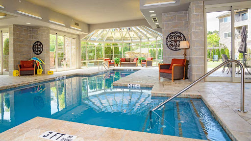 A serene indoor pool area with ample natural light, perfect for relaxation and leisure.