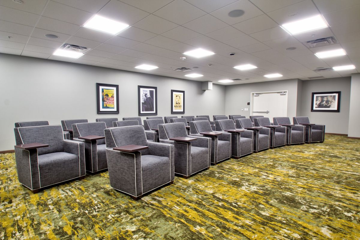 A modern conference room with a row of comfortable chairs and stylish decor.