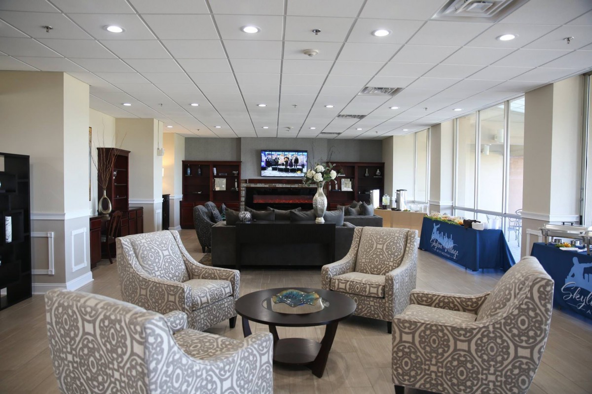 A spacious lobby with comfortable seating and a television.