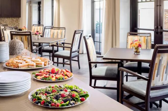 A restaurant dining area featuring a display of fresh salads and appetizers.