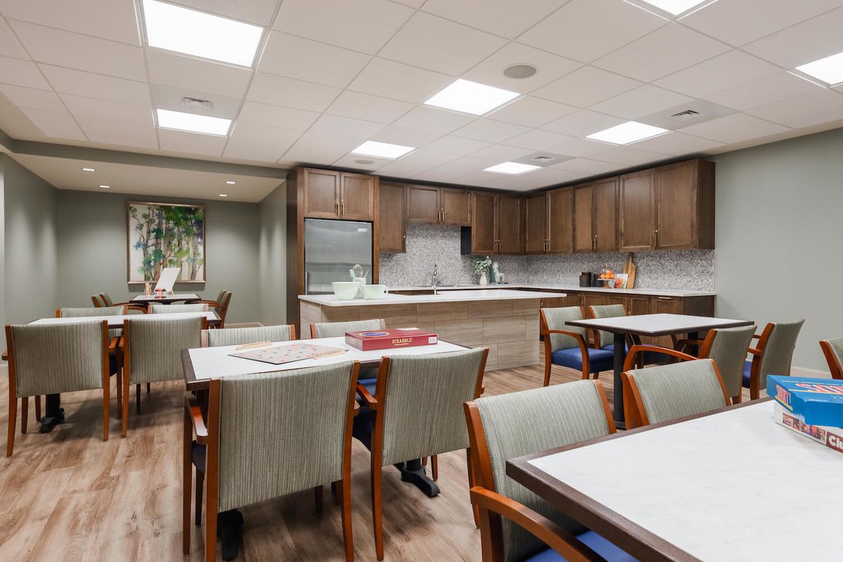 A modern kitchen and dining area with wooden cabinets and bright lighting.