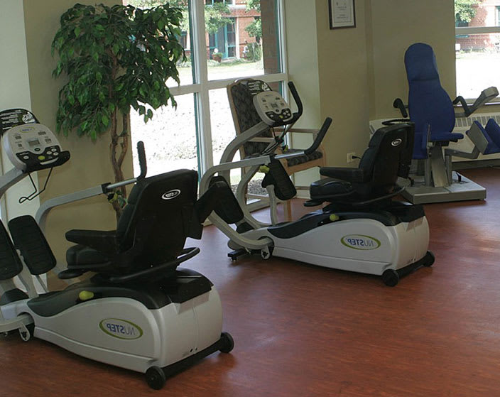 A fitness room with recumbent bikes and exercise equipment.
