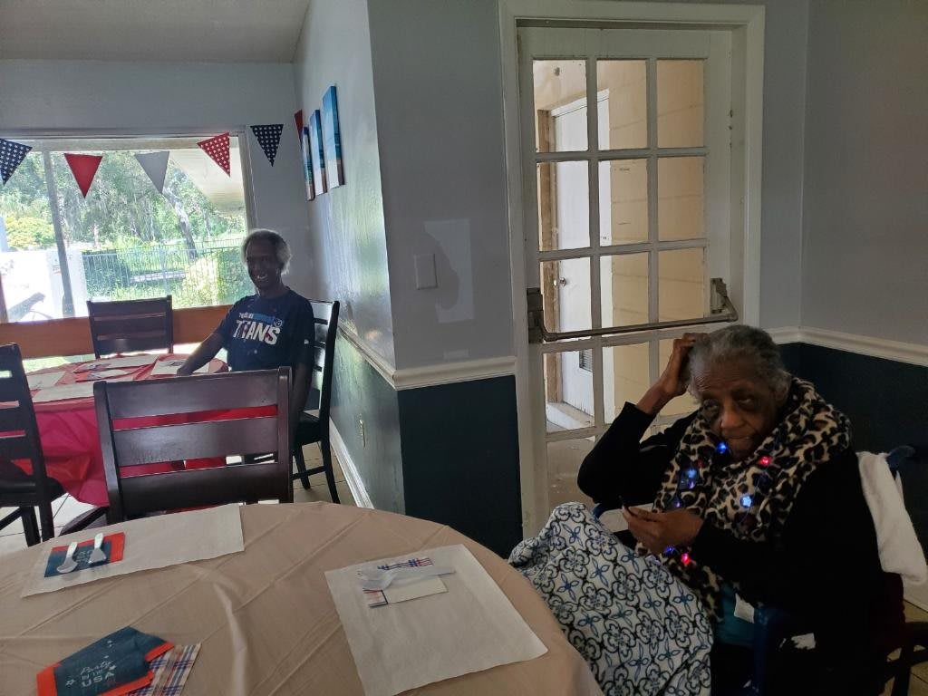 Two people relaxing in a decorated living room.