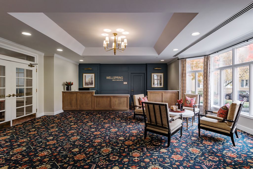 A stylish hotel lobby with a reception desk and a comfortable seating area.