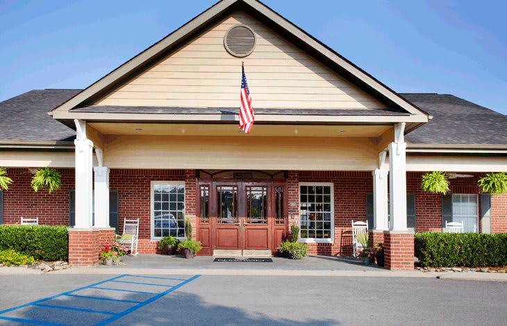 A building with a brick facade and an American flag above the entrance.