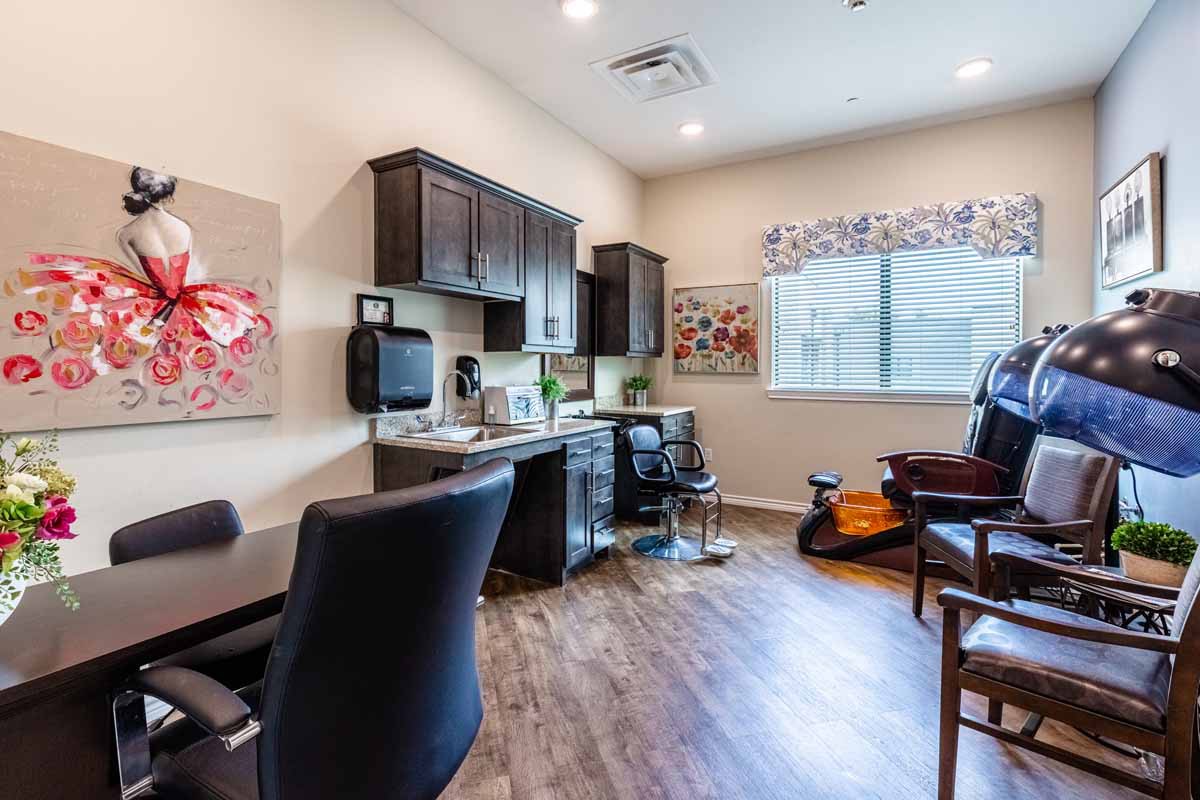 A modern office space featuring a desk, chairs, and decorative artwork.