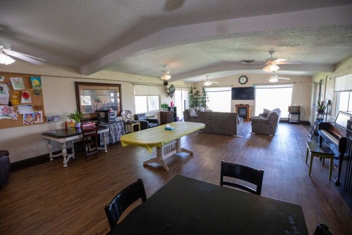 A spacious open-plan living and dining area with comfortable seating and ample natural light.