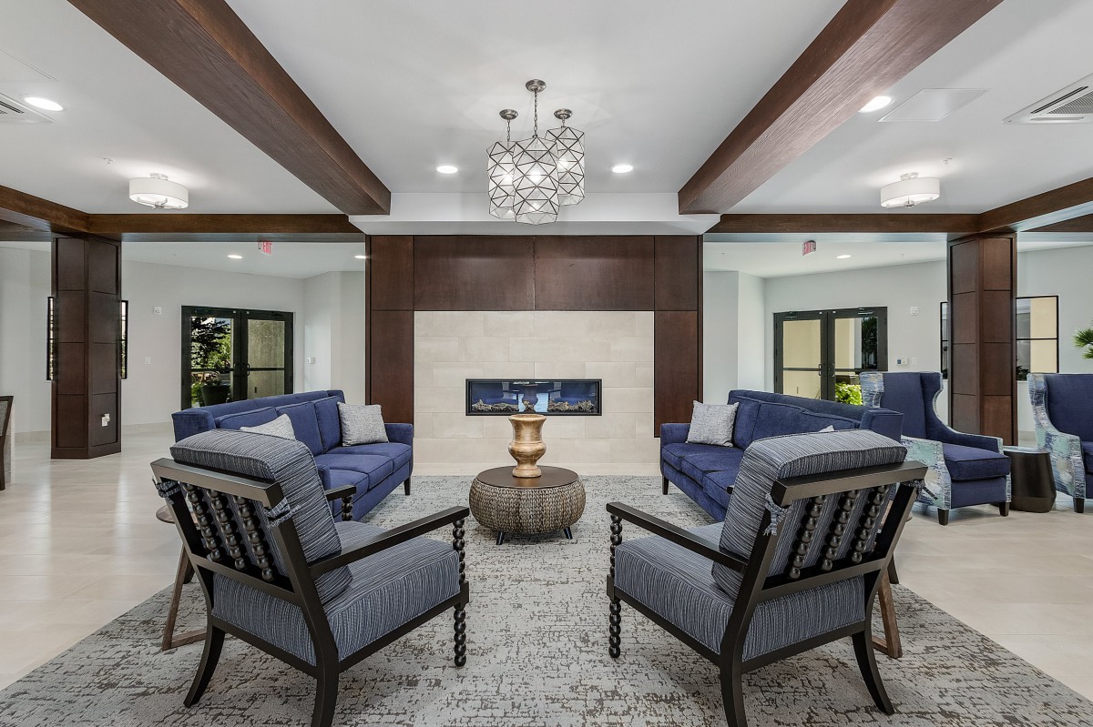 A modern living room with a central fireplace and elegant furnishings.