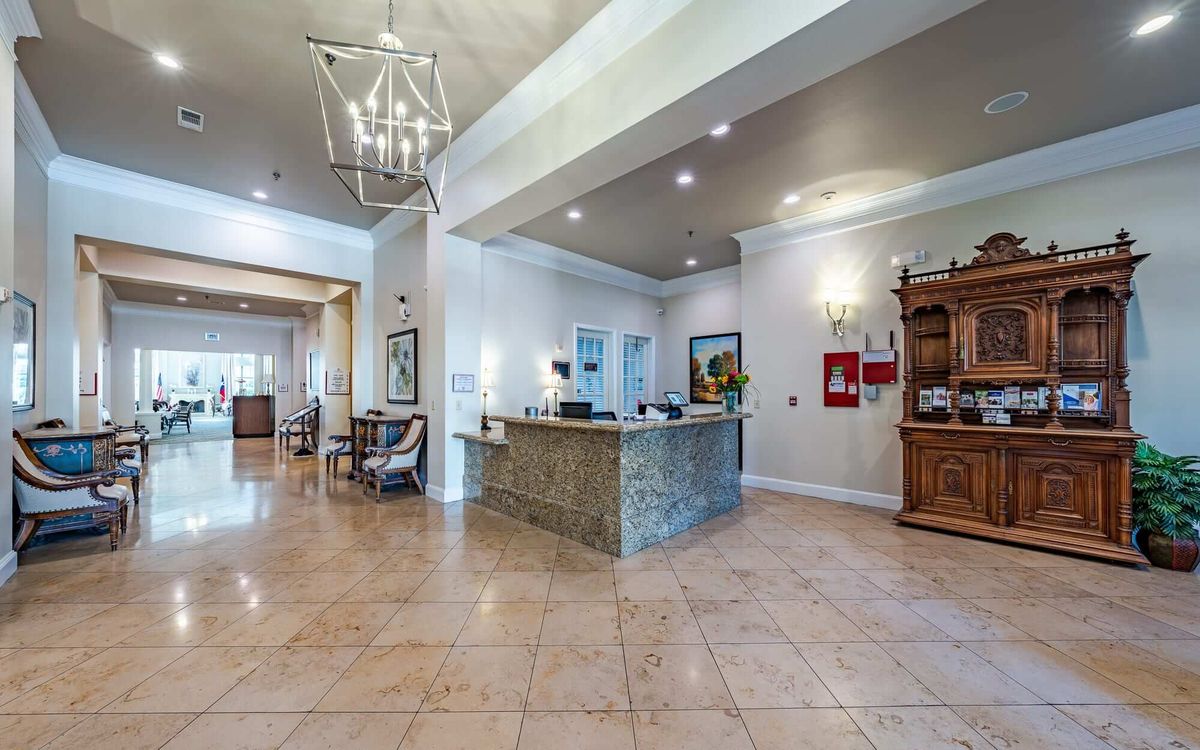 Spacious and elegant lobby with a reception desk and stylish decor.