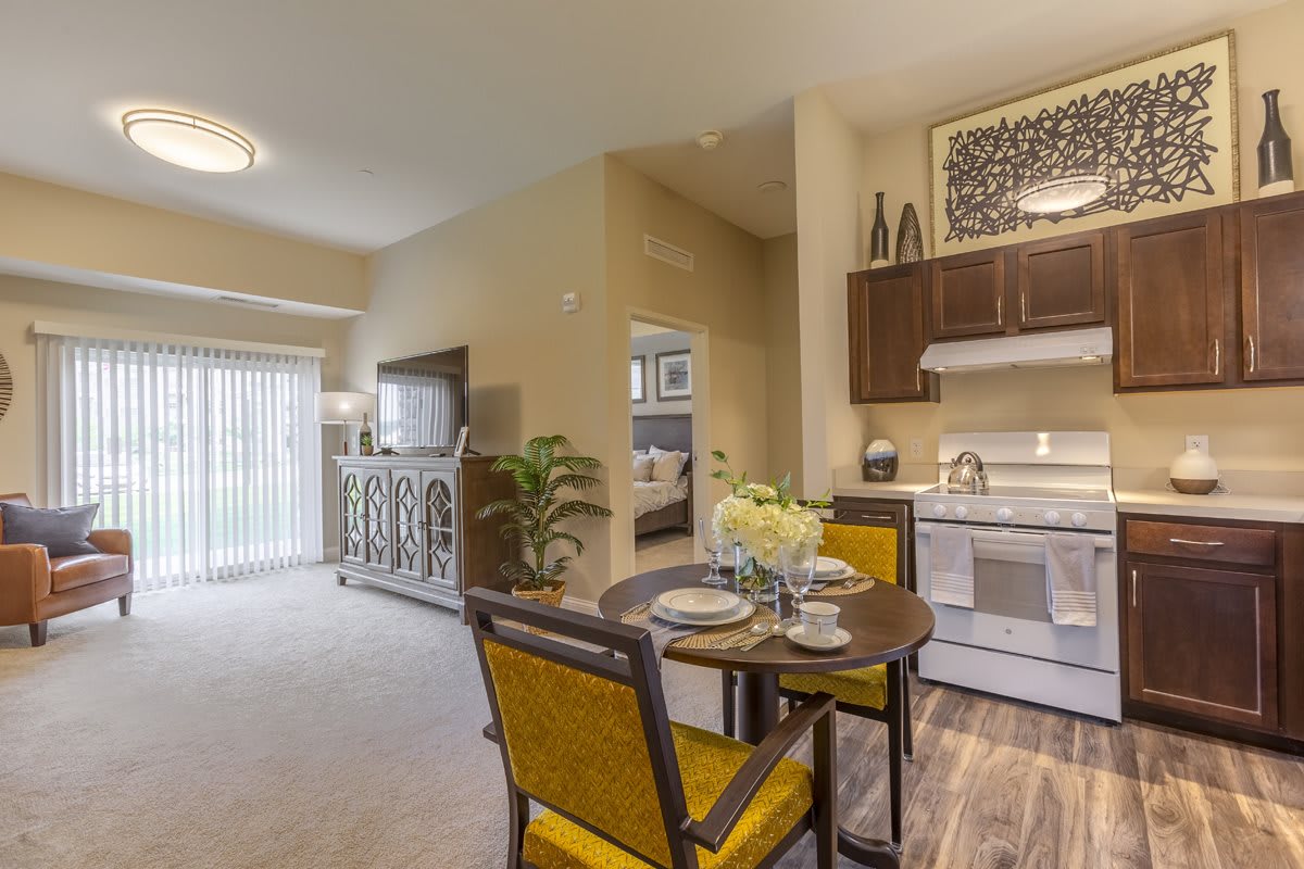 A modern apartment interior featuring an open living room, dining area, and kitchen.