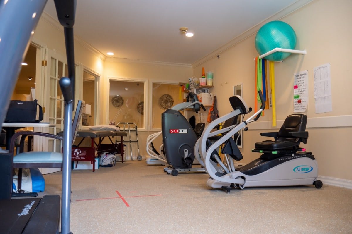 A home gym setup with various exercise machines and equipment.