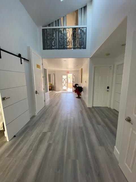 A modern hallway featuring sleek flooring and an abundance of natural light.