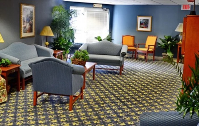 A cozy lobby with comfortable seating and indoor plants.
