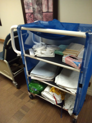 A hospital supply cart filled with various items, including linens and other essentials.