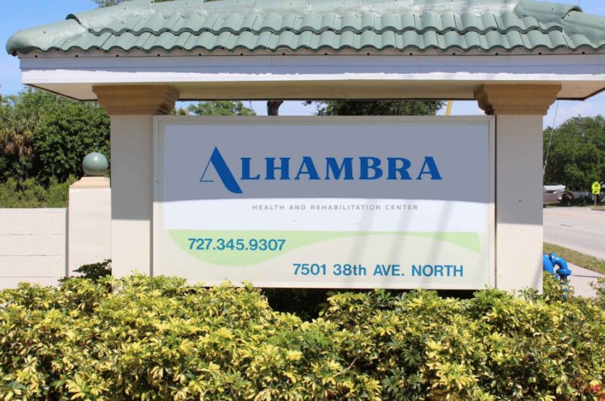 A photo of a sign displaying the name 'Alhambra' along with contact information and an address.