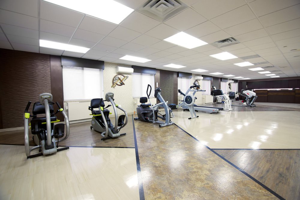 A well-equipped fitness center with various exercise machines including stationary bikes and treadmills.