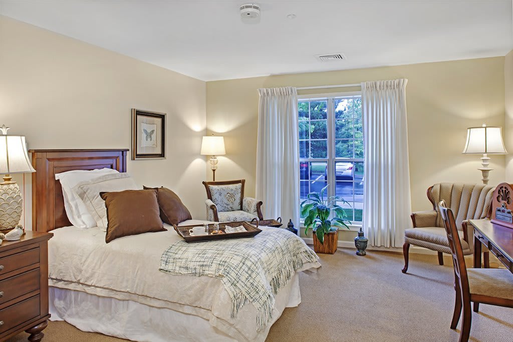 A cozy bedroom with elegant decor and natural lighting.