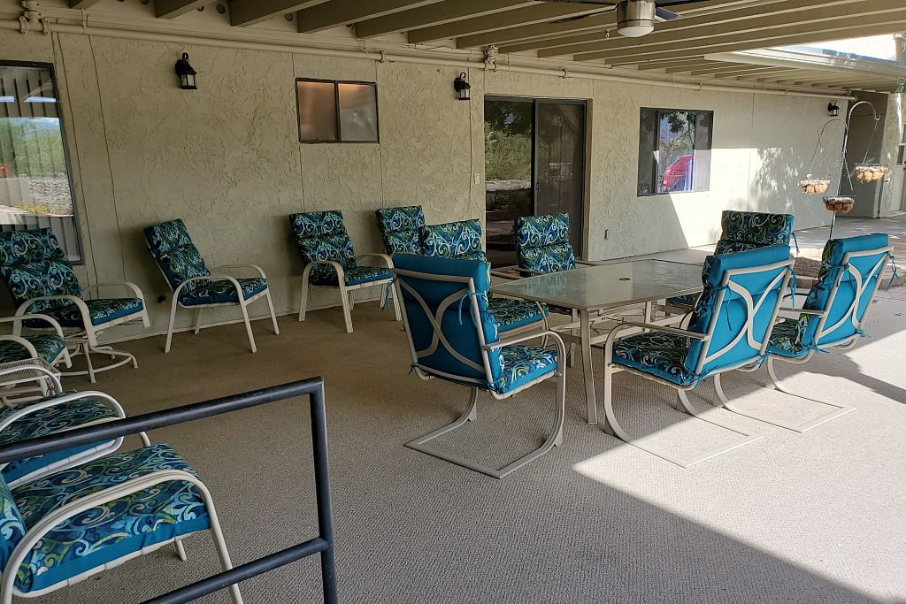A cozy outdoor patio with chairs and tables for relaxing.