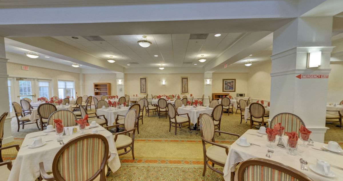 An elegant dining room with neatly arranged tables and chairs.