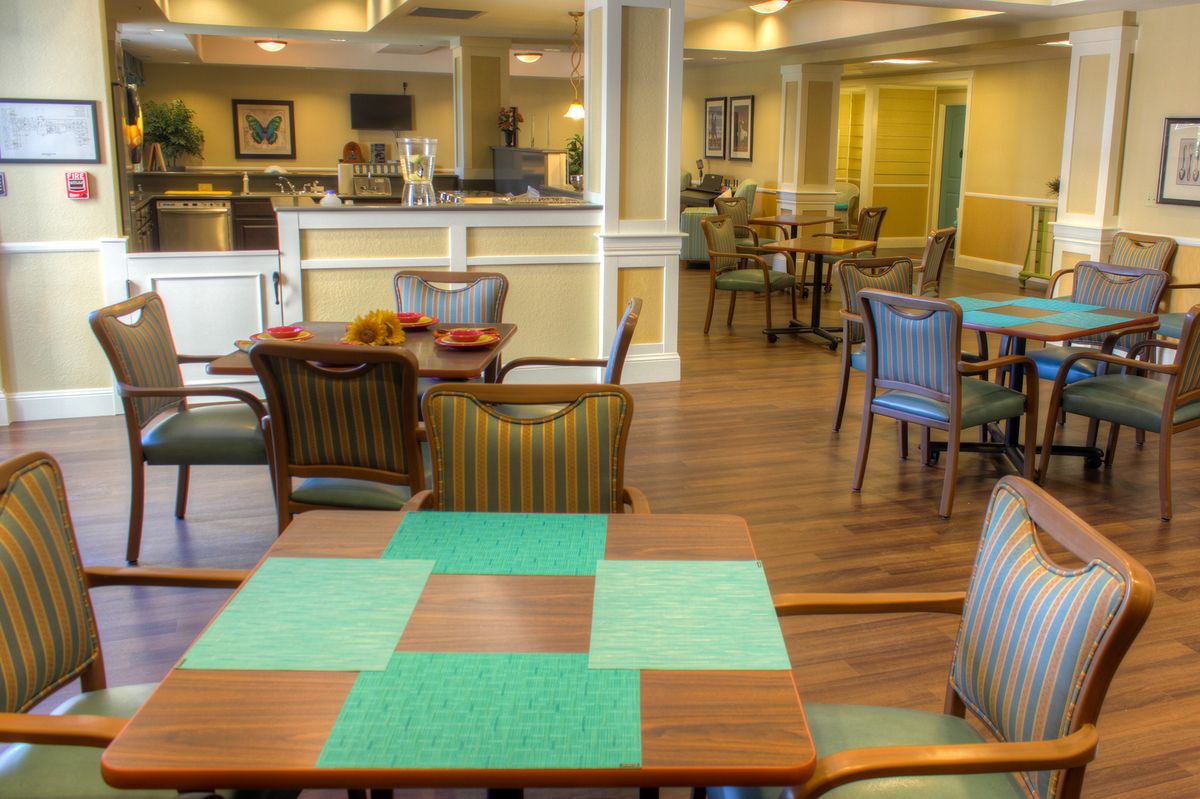 A cozy dining area with multiple tables and chairs in a well-lit room.