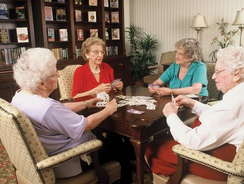 A group of elderly women enjoying a card game together.