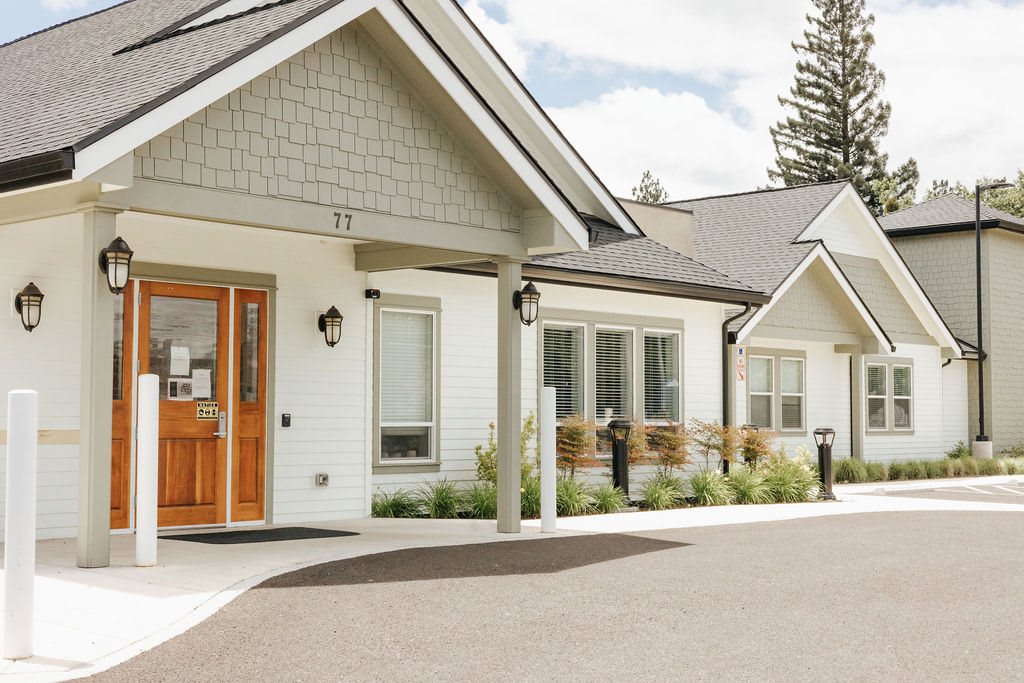 A modern residential building with a well-maintained exterior and driveway.