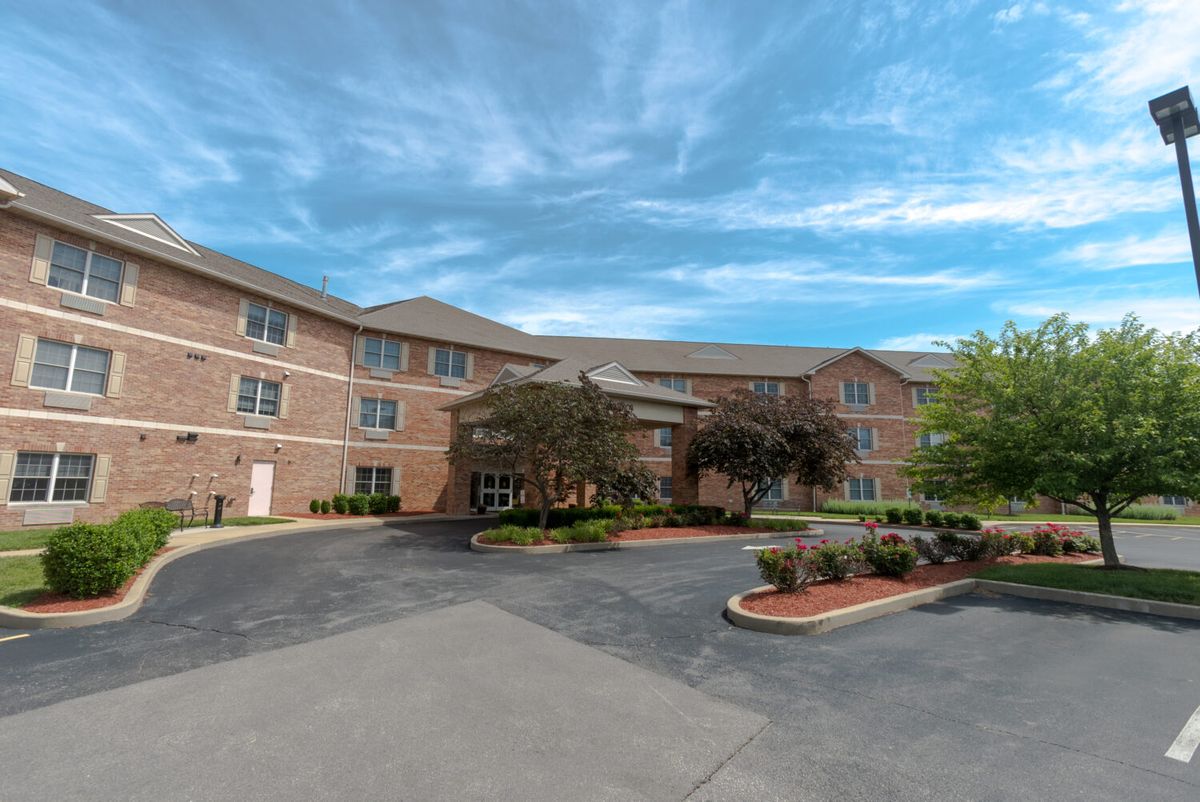 Exterior view of a multi-story hotel with a landscaped entrance.