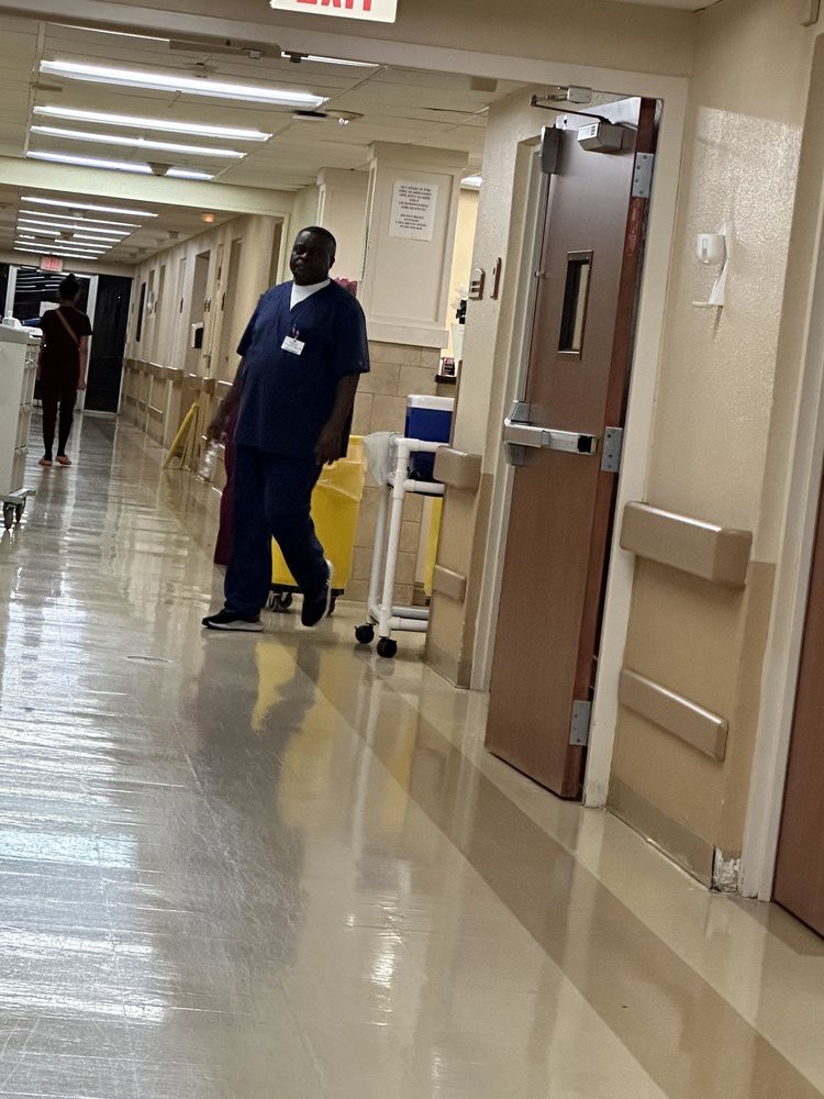 A nurse walks down a hospital corridor.
