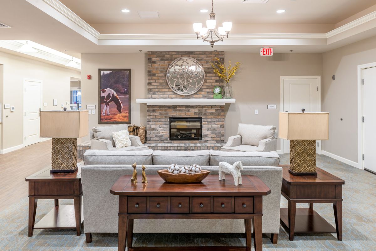 A cozy living room featuring a fireplace, comfortable sofas, and elegant decor.