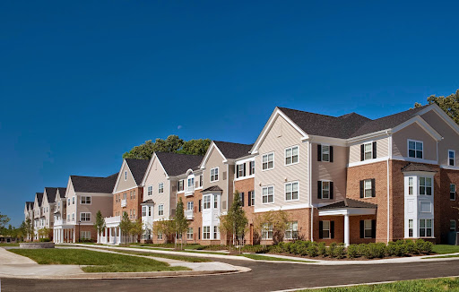 A row of modern apartment buildings under a clear blue sky.