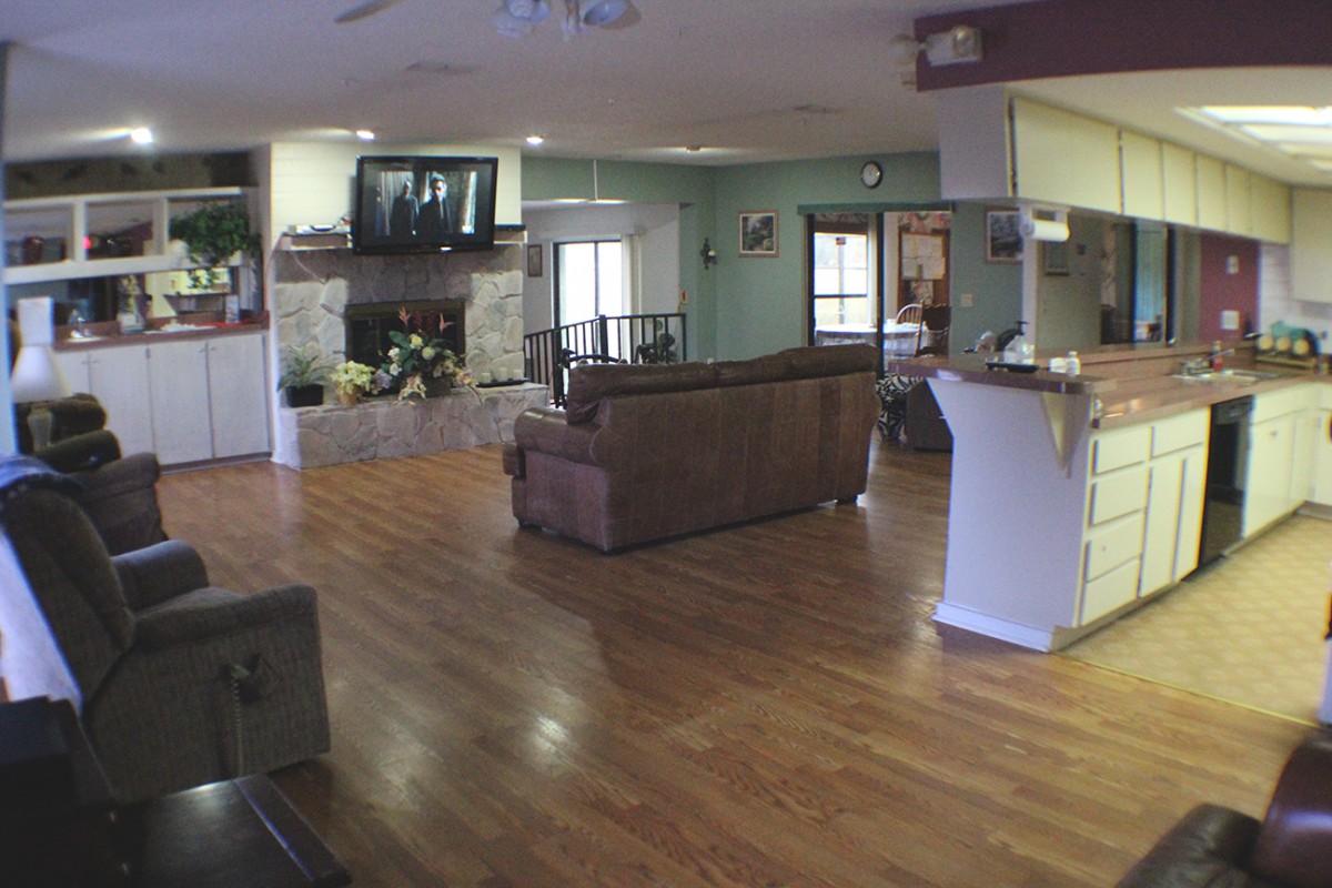 Spacious living room with hardwood flooring and a cozy seating area.