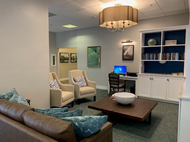 A cozy and modern living room with comfortable seating and a computer desk.
