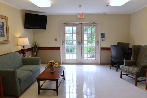A welcoming lobby area with a sofa, coffee table, and access to the outdoors.