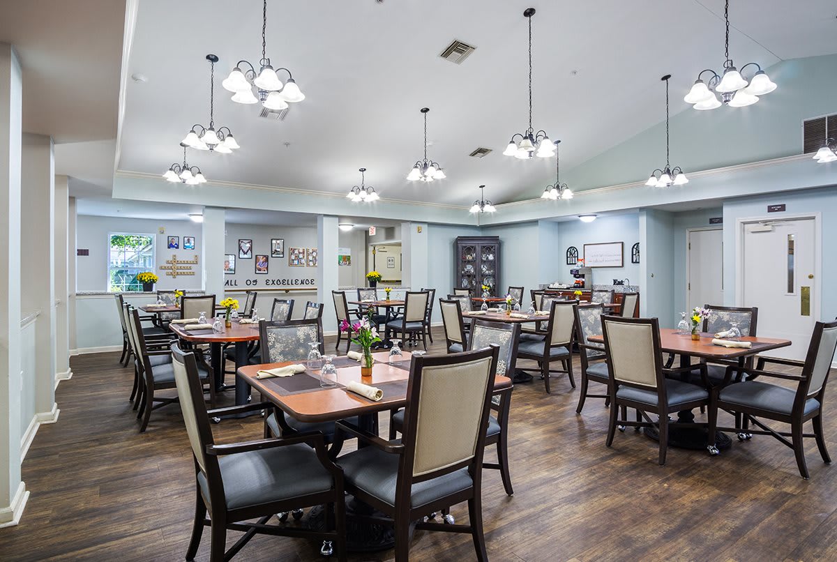 A well-lit dining area with neatly arranged tables and chairs.