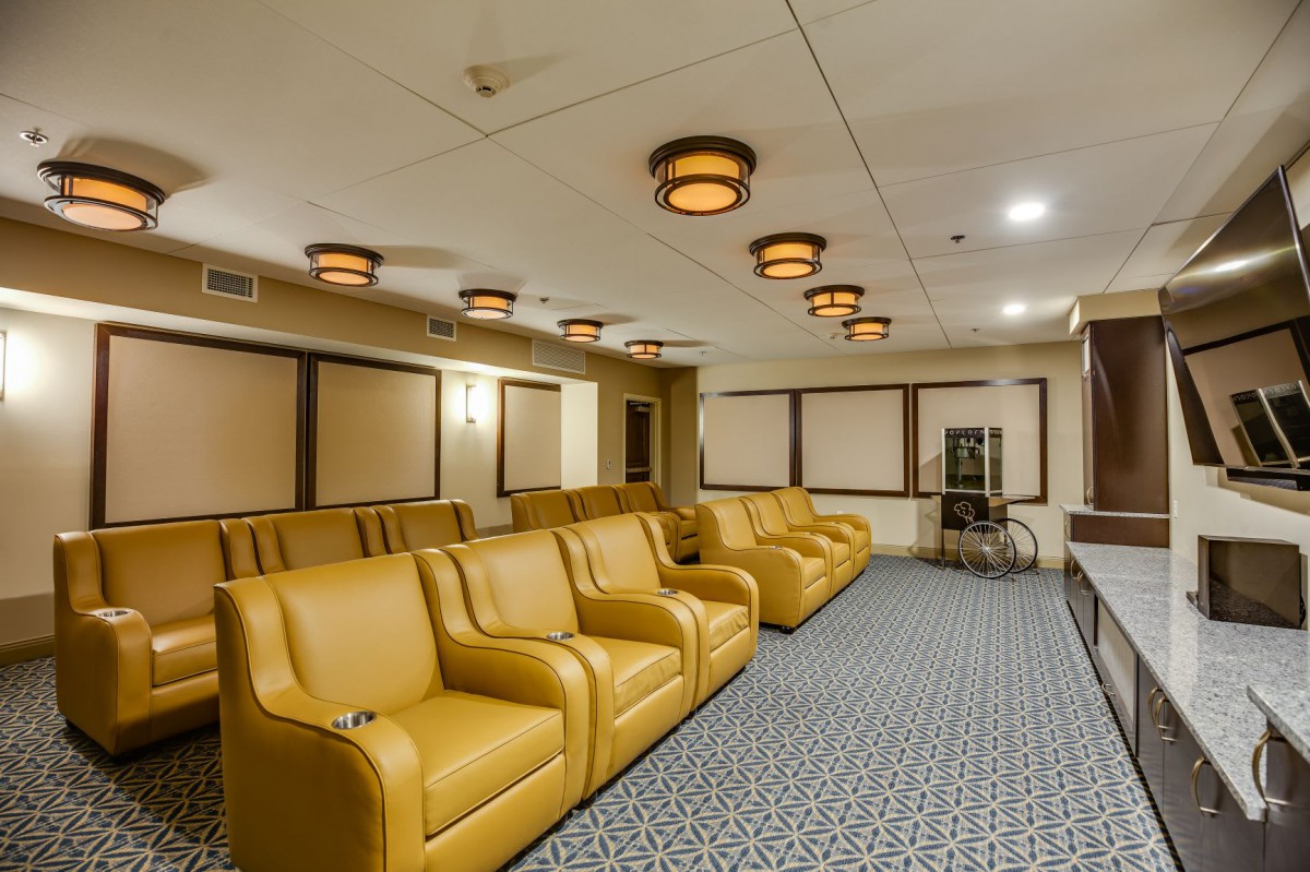 A stylish home theater room with plush seating and ambient lighting.