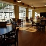A spacious dining area with large windows letting in natural light.