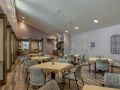 An empty dining area with tables and chairs arranged neatly.