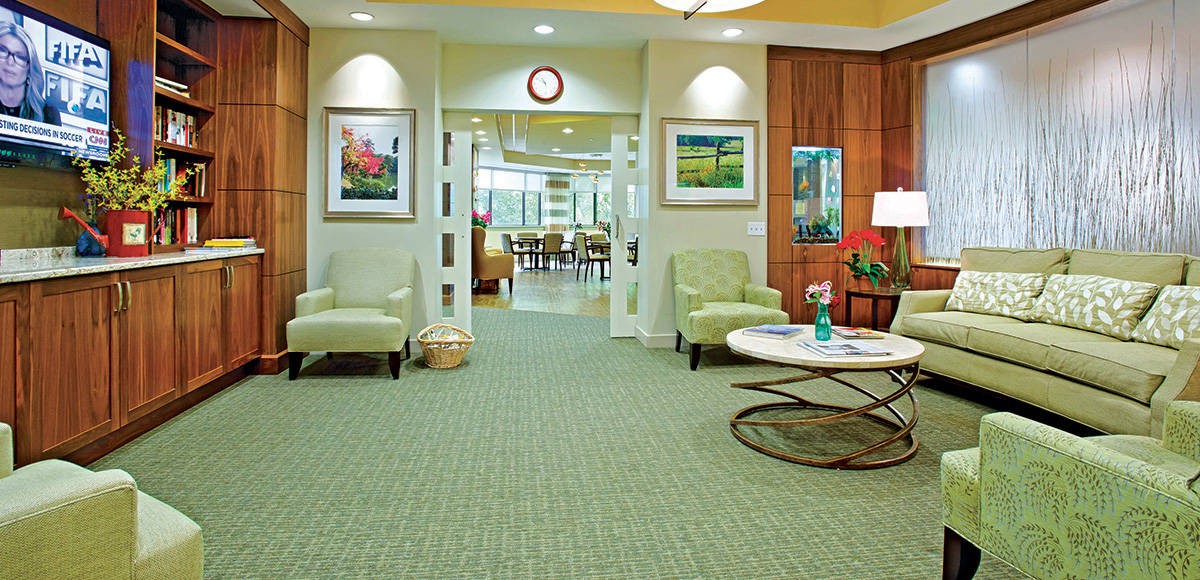 A well-furnished lobby area with comfortable seating and artwork on the walls.