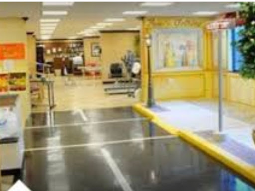 An accessible entrance leading into a brightly lit public space with seating areas.
