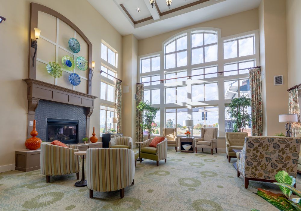 A spacious and well-lit lobby area featuring comfortable seating and large windows.