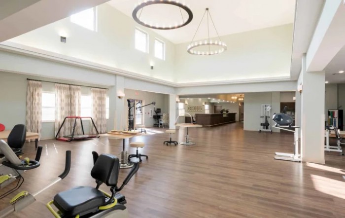 A spacious gym with various exercise equipment.
