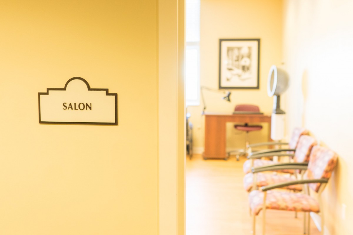 Interior view of a salon with chairs and a styling station.